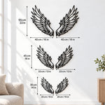 Black metal Celestial Angel wings wall art with intricate cutout details displayed on the wall