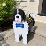 Newfoundland dog planter filled with fresh flowers is placed in the garden