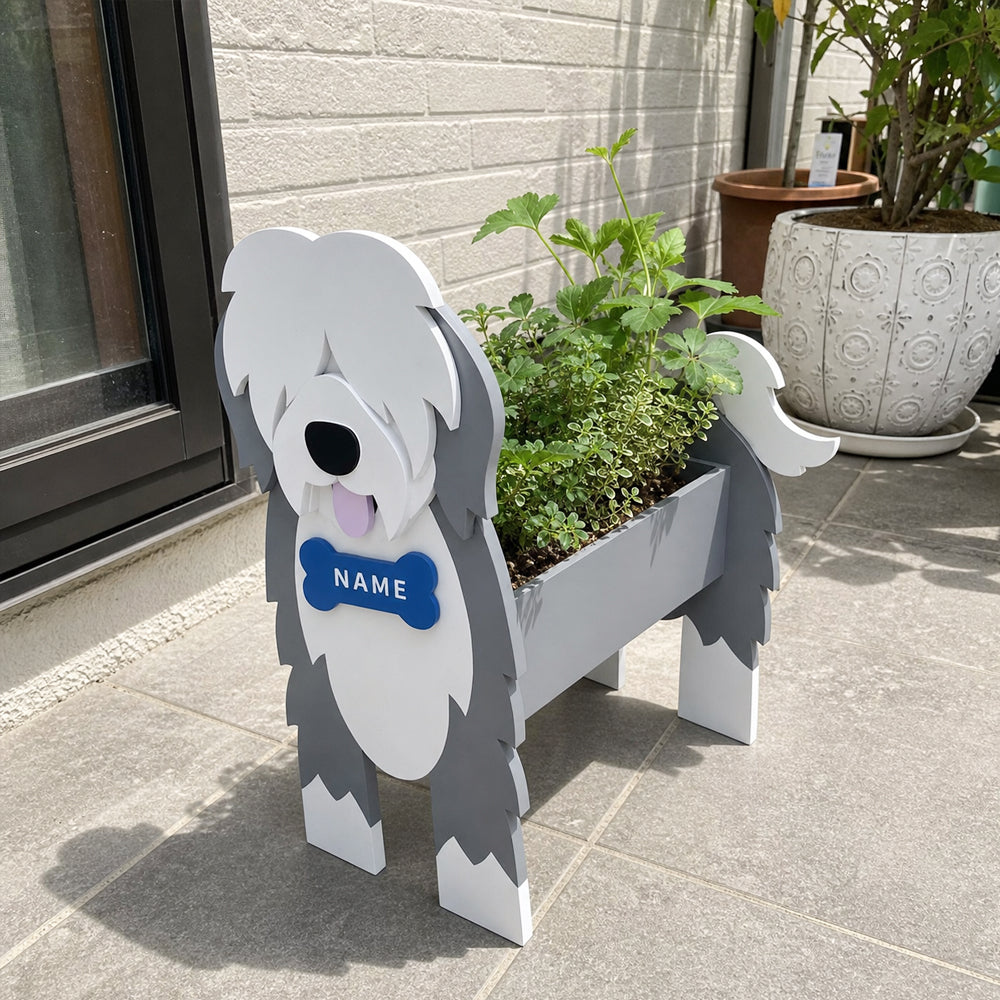 Old English Sheepdog  planter filled with fresh flowers is placed in the garden