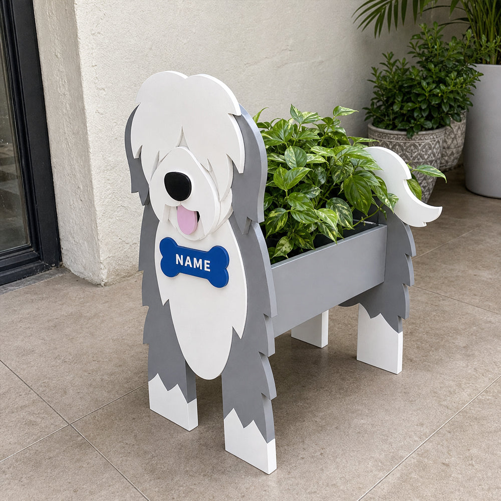 Old English Sheepdog  planter filled with fresh flowers is placed in the garden