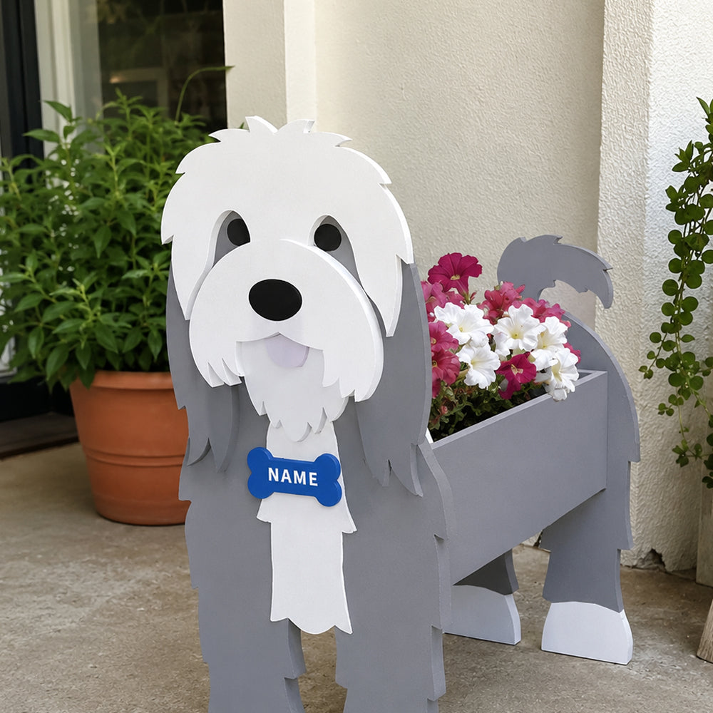 Old English Sheepdog  planter filled with fresh flowers is placed in the garden