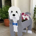 Old English Sheepdog  planter filled with fresh flowers is placed in the garden