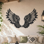 Black metal Ornate Angel wings wall art with intricate cutout details displayed on the wall