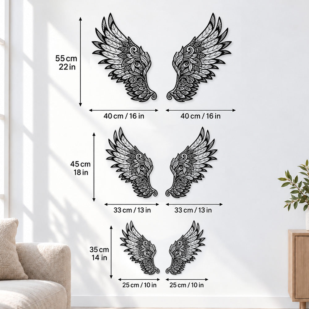 Black metal Ornate Angel wings wall art with intricate cutout details displayed on the wall