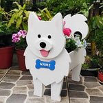 Samoyed dog planter filled with fresh flowers is placed in the garden