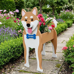 Shiba Inu dog planter filled with fresh flowers is placed in the garden