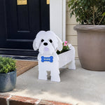 Shih Tzu dog planter filled with fresh flowers is placed in the garden