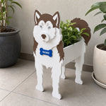 Siberian Husky dog planter filled with fresh flowers is placed in the garden
