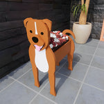 Staffordshire Bull Terrier dog planter filled with fresh flowers is placed in the garden