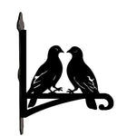 Two lovebirds on branch metal hanging basket bracket mounted on outdoor wall for plant decoration