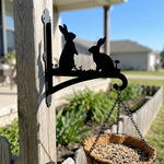 Two rabbits metal hanging basket bracket mounted on outdoor wall for plant decoration