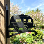 Vintage camper metal hanging basket bracket mounted on outdoor wall for plant decoration