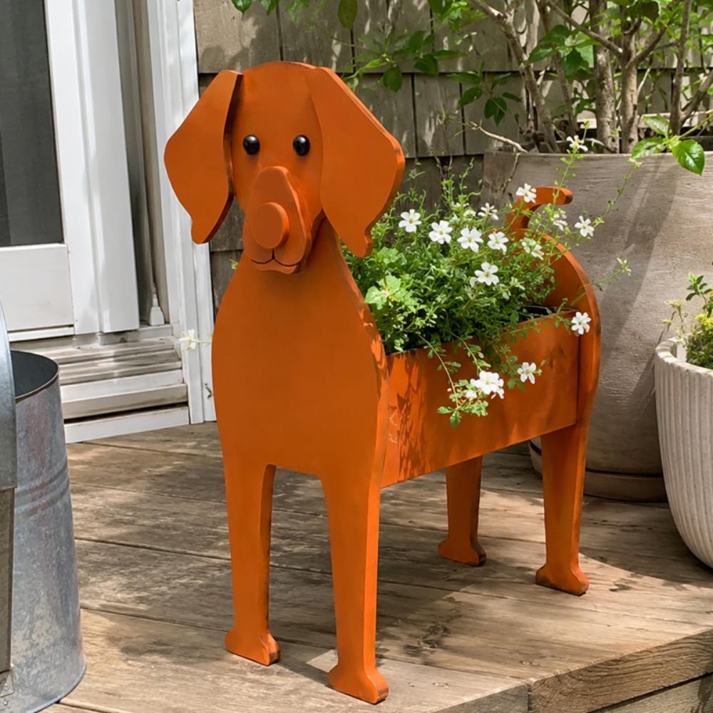 Vizsla dog planter filled with fresh flowers is placed in the garden