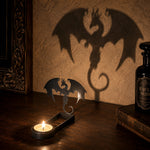 Winged dragon halloween metal candle holder casting a spooky shadow on the wall