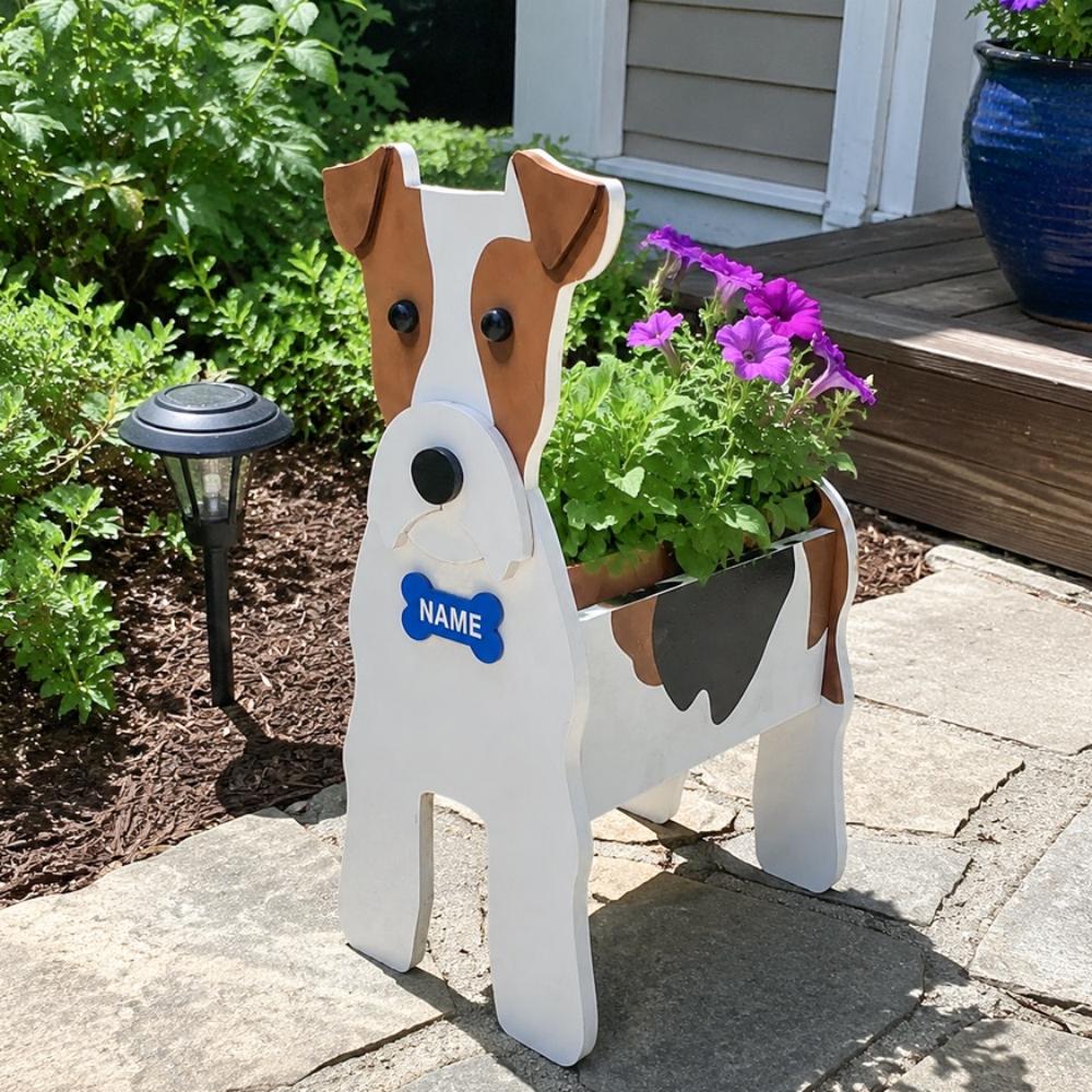 Wire Fox Terrier dog planter filled with fresh flowers is placed in the garden