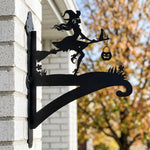 Witch and black cat metal hanging basket bracket mounted on outdoor wall for plant decoration