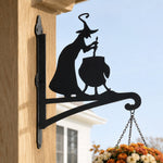 Witch and cauldron metal hanging basket bracket mounted on outdoor wall for plant decoration