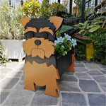 Yorkshire Terrier dog planter filled with fresh flowers is placed in the garden